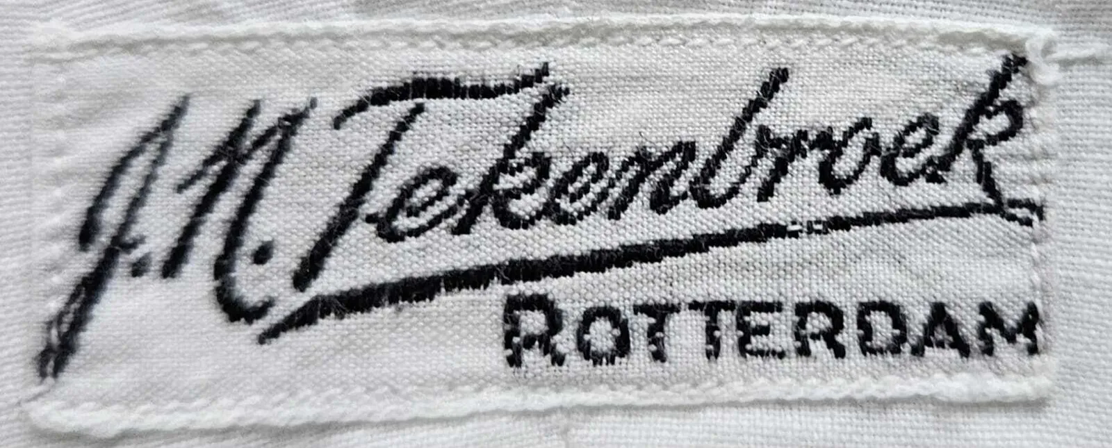 Label met tekst J.N. Tekenbroek / Rotterdam