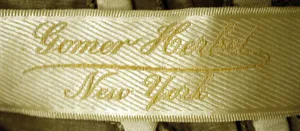 Label met tekst Gomer Herbel / New York