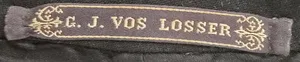 Label met tekst G.J. Vos / Losser